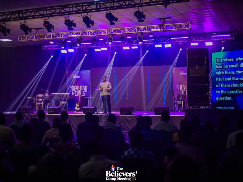 The main stage with scripture on screen and the congregation gathered.