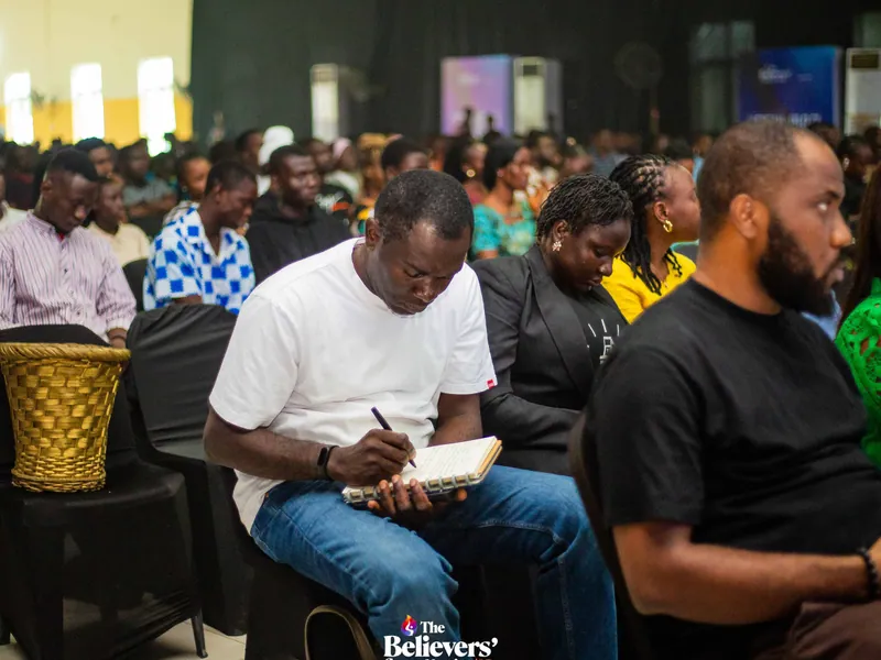 An attendee taking notes during a teaching session.